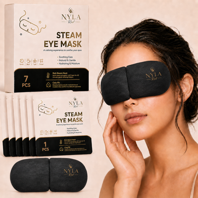 Woman wearing Nyla Rest Steam Eye Mask, resting on a beige background